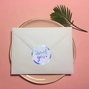 Round holographic thank you sticker on a white envelope for elegant gift package sealing