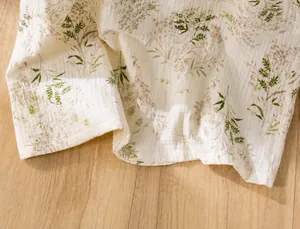 Close-up detail of the neat hemline and stitching on floral cotton gauze nightgown