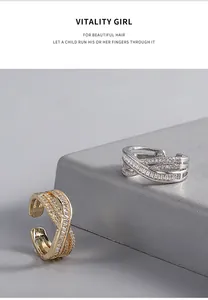 Macro view of gold and silver criss-cross rings with sparkling cubic zirconia