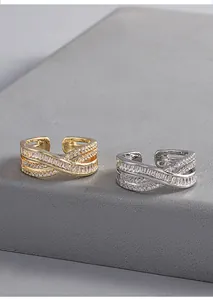 Detail of criss-cross copper rings with pave cubic zirconia in gold and silver finish