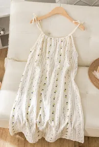 Detailed view of a sweet floral cotton gauze slip nightdress in a cozy home setting