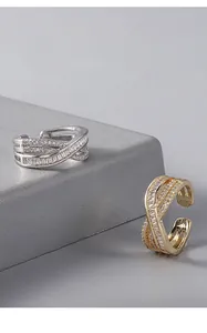 Close-up detail of silver and gold plated twisted rings with sparkling cubic zircon inlay