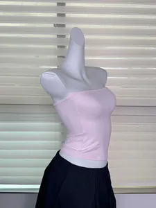 Side view of a pink seamless elastic tube top displayed on a white mannequin torso