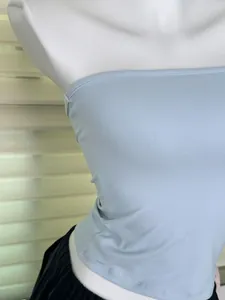 Close-up of light blue elastic tube top showing soft texture and fit on mannequin.