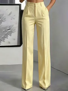Detail view of high-waist yellow striped wide-leg trousers for a stylish commuter look