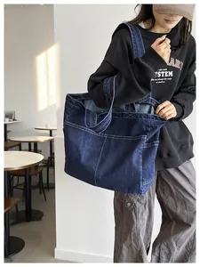 Large capacity Japanese style denim tote bag shown worn by model in a cafe setting