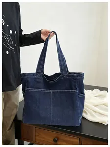 Close-up of a large capacity navy denim tote bag with contrast stitching detail