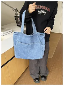 Close-up of blue denim tote bag with multiple pockets in a lifestyle setting