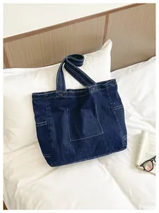 Large capacity navy blue denim shoulder bag with white stitching detail.