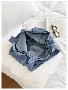 Detailed interior view of the large capacity blue denim tote bag with zipper closure