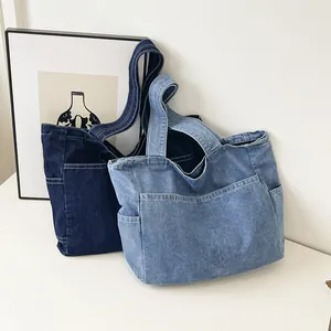 Pair of minimalist Japanese-style denim tote bags in dark and light blue colors