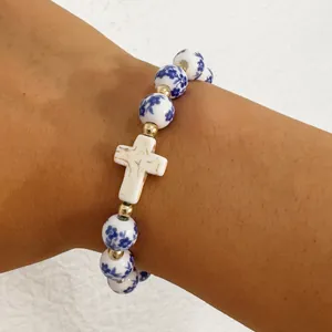 Elegant blue and white porcelain beaded bracelet with a white cross pendant for women