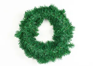 Detail of lush green PVC Christmas wreath for door and window festive holiday decor.