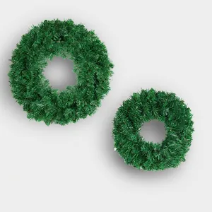 Set of two lush green artificial PVC Christmas wreaths for festive door and home decor