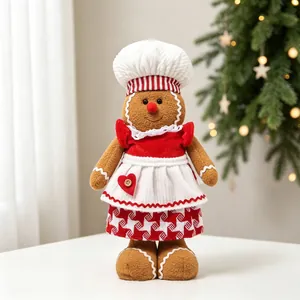 Gros plan d'un adorable bonhomme de pain d'épices en peluche déguisé en chef de Noël
