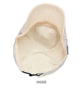 Detailed macro view of the interior lining and mesh structure of a beige summer flat cap