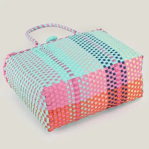 Vibrant colorful hand-woven plastic tote bag perfect for beach vacation and picnic use.