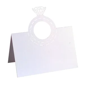 Detailed view of an elegant white laser cut diamond ring place card for weddings