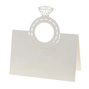 Close-up showing the intricate laser-cut diamond ring detail on a white wedding place card