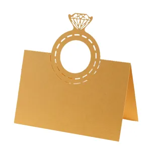 Detail view of a laser-cut diamond ring place card made of premium gold kraft paper
