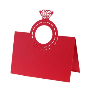 Macro detail showing the intricate laser-cut diamond ring design on this red wedding place card