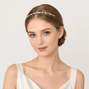 Detail shot of a delicate silver rhinestone flower headband on a woman's hair.