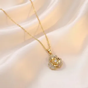 Elegant gold-tone necklace featuring a rotating rose pendant with sparkling zirconia details.