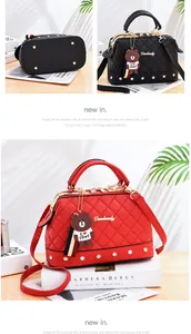 Quilted diamond handbag with cartoon bear charm, available in black and red colors