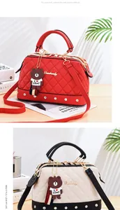 Detailed view of quilted doctor handbags with cartoon bear charms in red and beige colors.