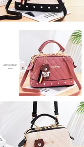 Quilted pink crossbody handbag featuring decorative studs and a cartoon bear pendant detail