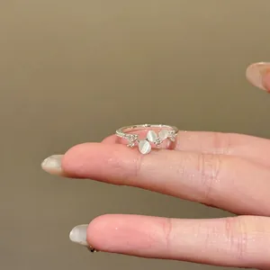 Minimalist silver-toned adjustable ring featuring zircon stones and cat eye opal accents