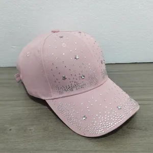 Detailed view of a pink women's baseball cap featuring sparkling silver rhinestone stars