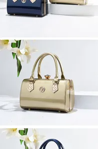 Detailed view of elegant gold patent leather handbag with sparkling gemstone clasp closure