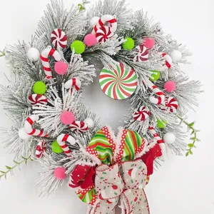 Detailed view of a frosted Christmas wreath with candy canes and colorful ornaments