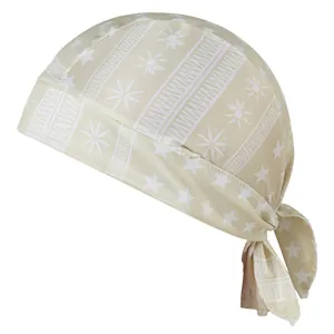 Macro view of beige bandana featuring white star and sun patterns with soft elastic fabric