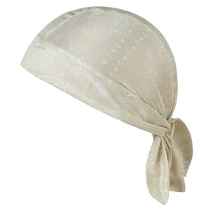 Detail view of champagne paisley durag featuring elastic fabric and adjustable tie-back