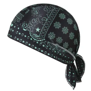 Detail view of elastic black pirate hat with green paisley and snowflake patterns.