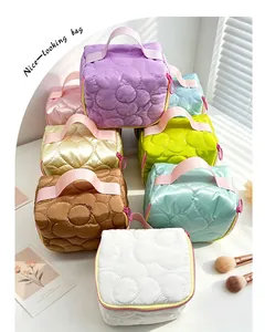 Detailed view of quilted cosmetic bags in several pastel colors and cute patterns