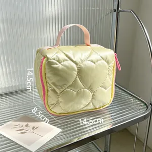 Detailed view of champagne heart quilted makeup bag with dimensions 14.5x8.5x14.5cm