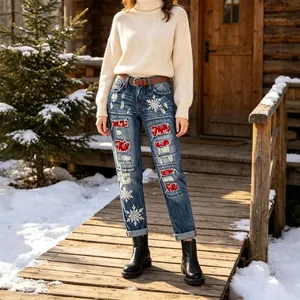 Fashionable Christmas themed women's straight leg ripped jeans with festive snowflake patches