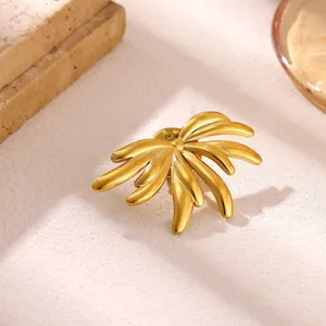 Vue détaillée d'une broche géométrique en acier inoxydable doré au design de soleil.
