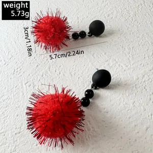 Detail view of red tinsel fuzzy ball earrings with size and weight measurements shown.