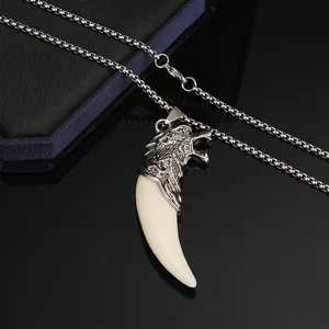 Detail of masculine retro wolf tooth pendant with stainless steel box chain for men