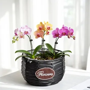 Detailed view of a handmade black woven orchid basket with decorative 'Flowers' patch