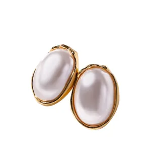 Elegant French vintage style faux pearl earrings with a gold-tone geometric border.