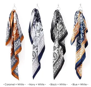 Detailed view of paisley pattern silk scarves in four elegant color combinations