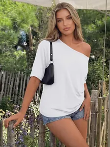 Outdoor fashion detail of a white one-shoulder oversized t-shirt for women