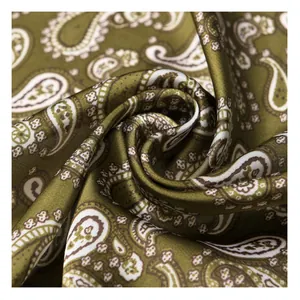 Macro detail of olive green vintage paisley pattern silk square scarf texture and drape