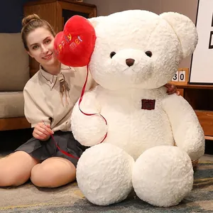 Large white plush teddy bear with a red heart balloon, ideal Valentine's Day gift.