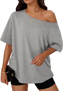 Detail view of a grey off-shoulder loose T-shirt styled with minimalist accessories